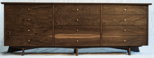 A wooden dresser with four drawers and two doors.