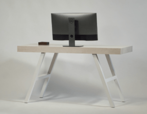 A desk with a monitor and a phone on it