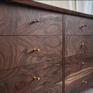 A close up of the drawers on a dresser