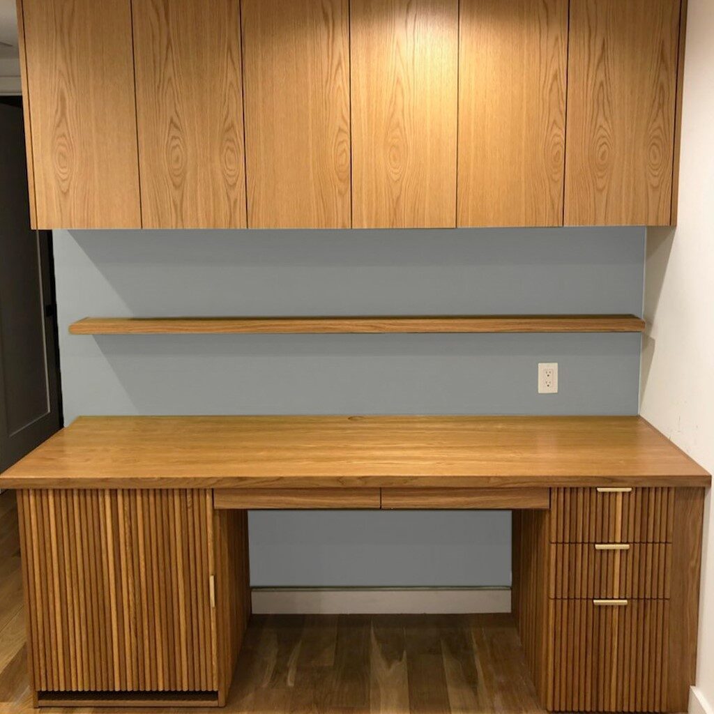 A wooden dresser with gold knobs and handles.