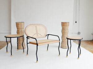 A set of four chairs and two tables with metal legs.