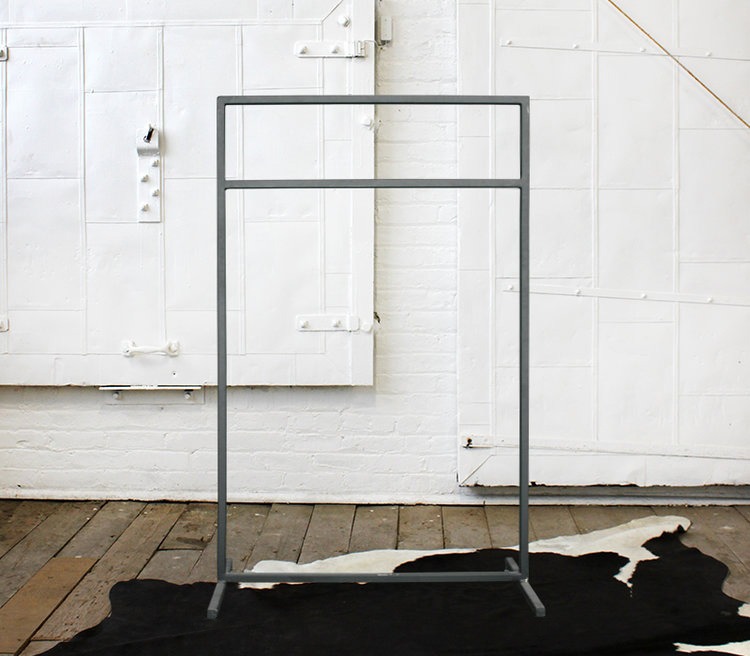 A metal rack with a cow hide rug in front of it