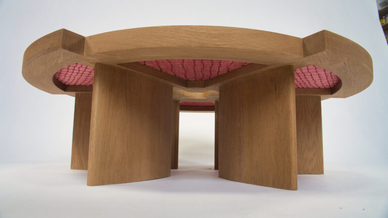 A wooden table with pink top and two large doors.