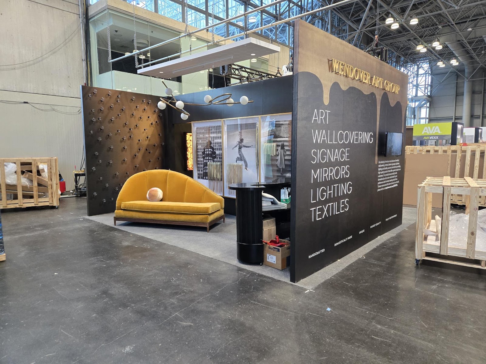 A yellow couch and chair in front of a black wall.