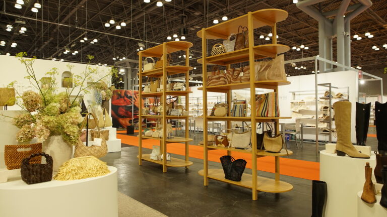 Close up of Dolce Vita displaying hand bags on custom white oak shelves.