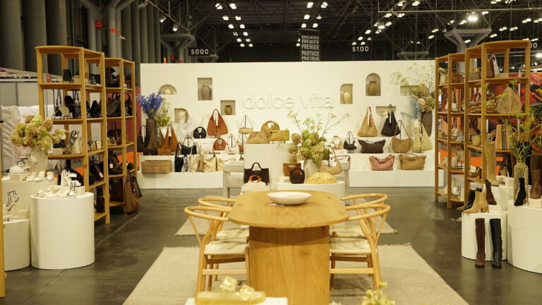 Wide booth view of Dolce Vita’s custom display with shelving and products